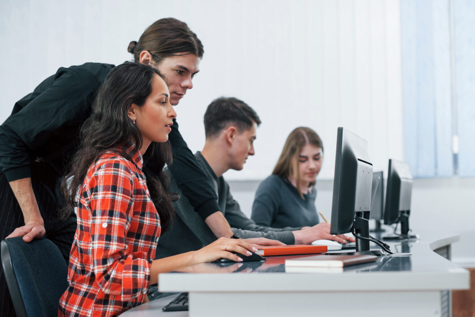 Am I doing it right. Group of young people in casual clothes working in the modern office.